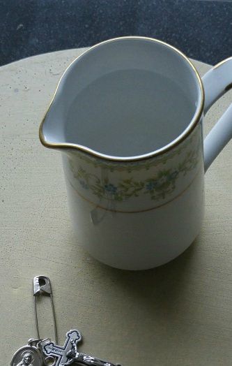 Idea:  keep a small jug of blessed water on your kitchen counter, and hang the medal of the Sacred Heart and the Crucifix nearby.